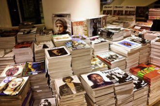 Sort magazines and store them in decorative boxes for an organized space